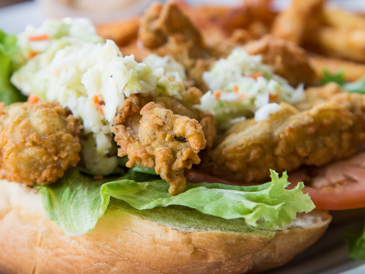 Fried Oyster Po-Boy Sandwich Topped with Cole Slaw