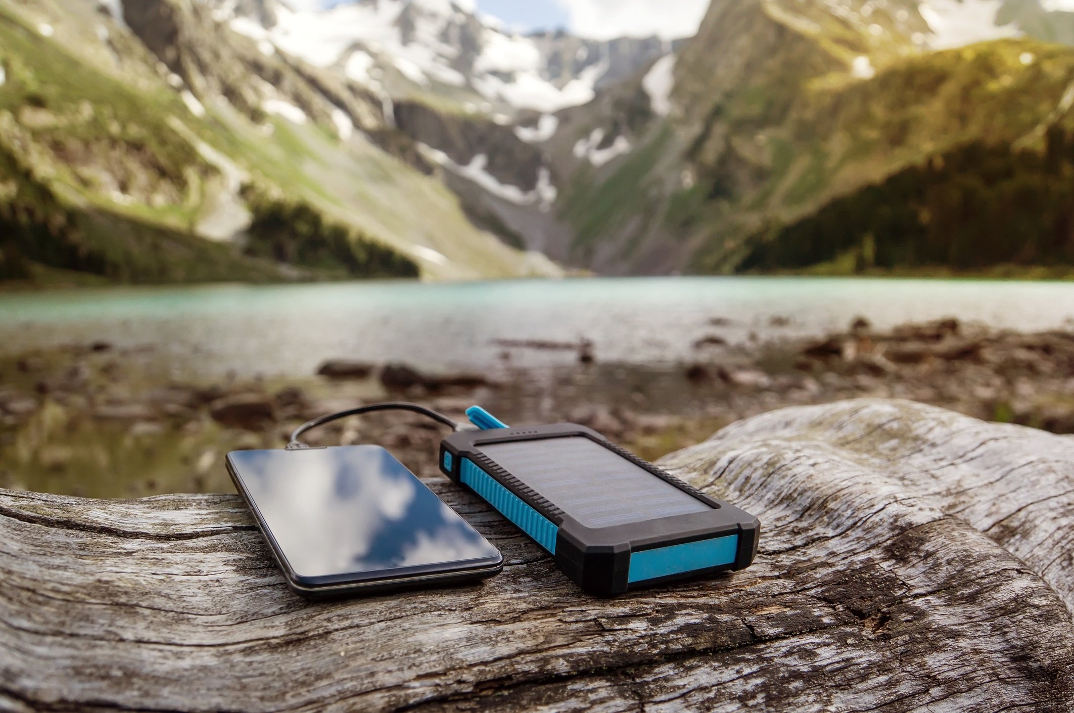 Battery solar energy device on the background of beautiful mountain scenery.