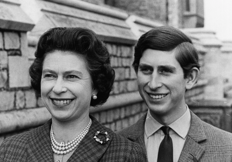An archived photo of Queen Elizabeth and prince Charles smiling together.  An archived photo of Queen Elizabeth and prince Charles smiling together.