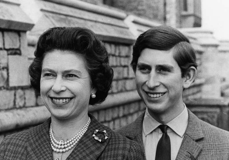 An archived photo of Queen Elizabeth and prince Charles smiling together. 