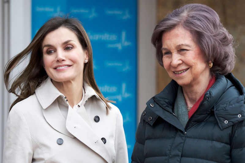Queen Letizia stands next to Queen Sofia outside building. 