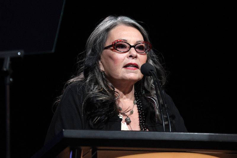 Roseanne Barr speaking at a podium. Roseanne Barr speaking at a podium.