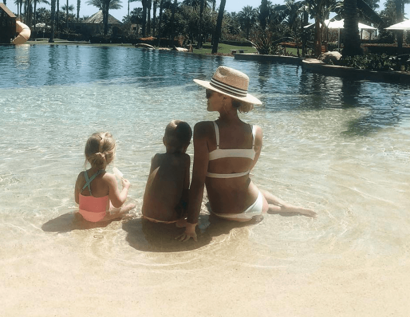 Kristin Cavallari and her two kids sit on a beach Kristin Cavallari and her two kids sit on a beach