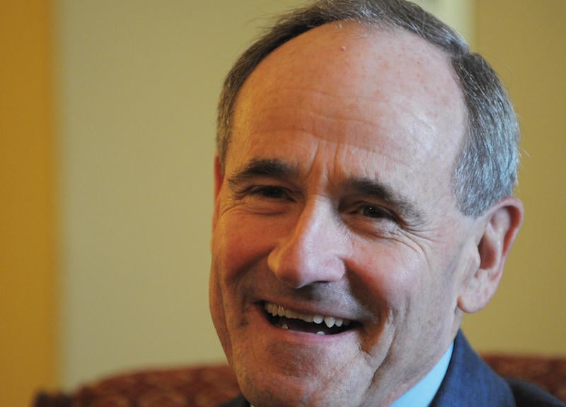 Jim Risch sits on a couch and smiles. Jim Risch sits on a couch and smiles.