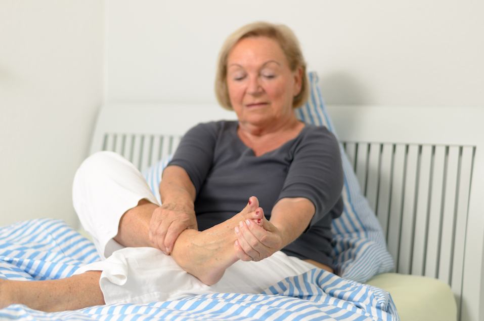 Woman massaging her feet Woman massaging her feet