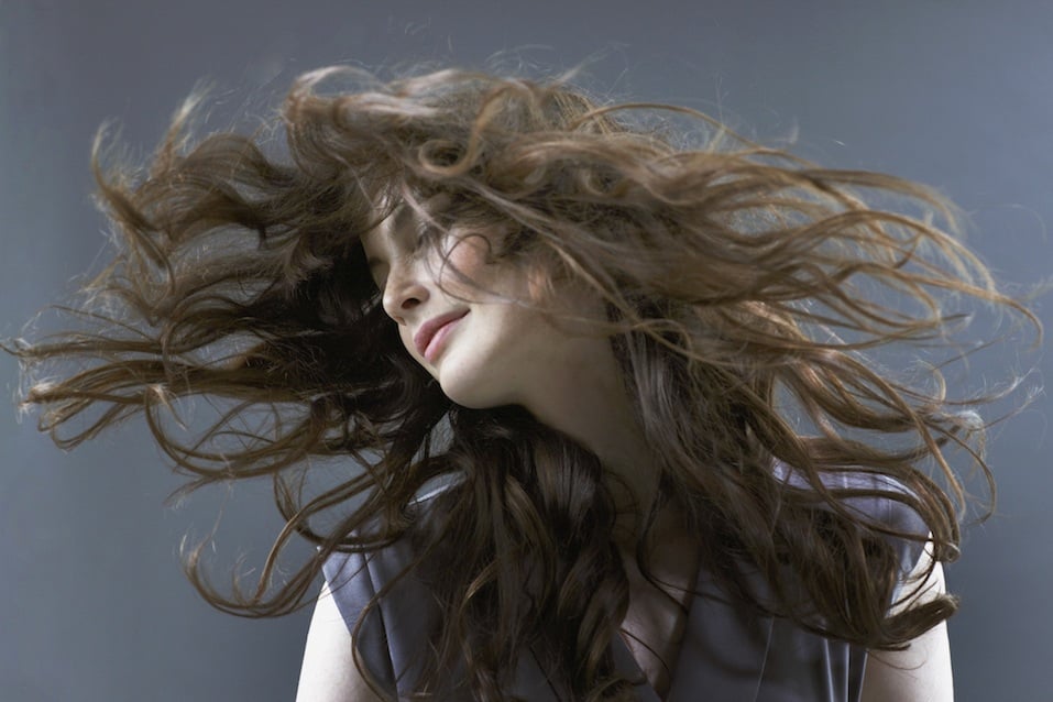 Smiling woman flipping hair