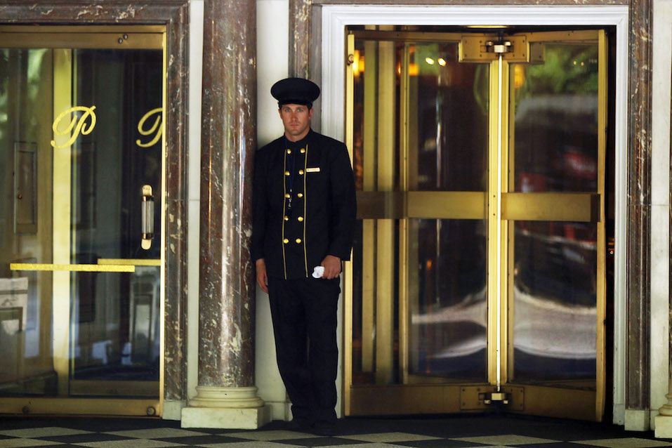 A doorman stands in front of the Pierre Hotel