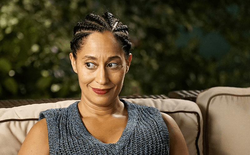 Tracee Ellis Ross sits on a sofa in 'Black-ish'. 