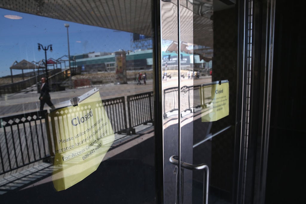Signs hang from the doors of the closed Trump Plaza hotel