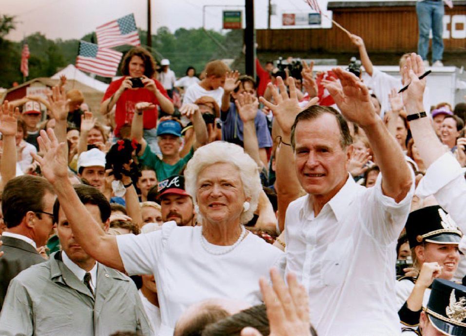 U.S. President George Bush and wife, Barbara, wave to a crowd of supporters