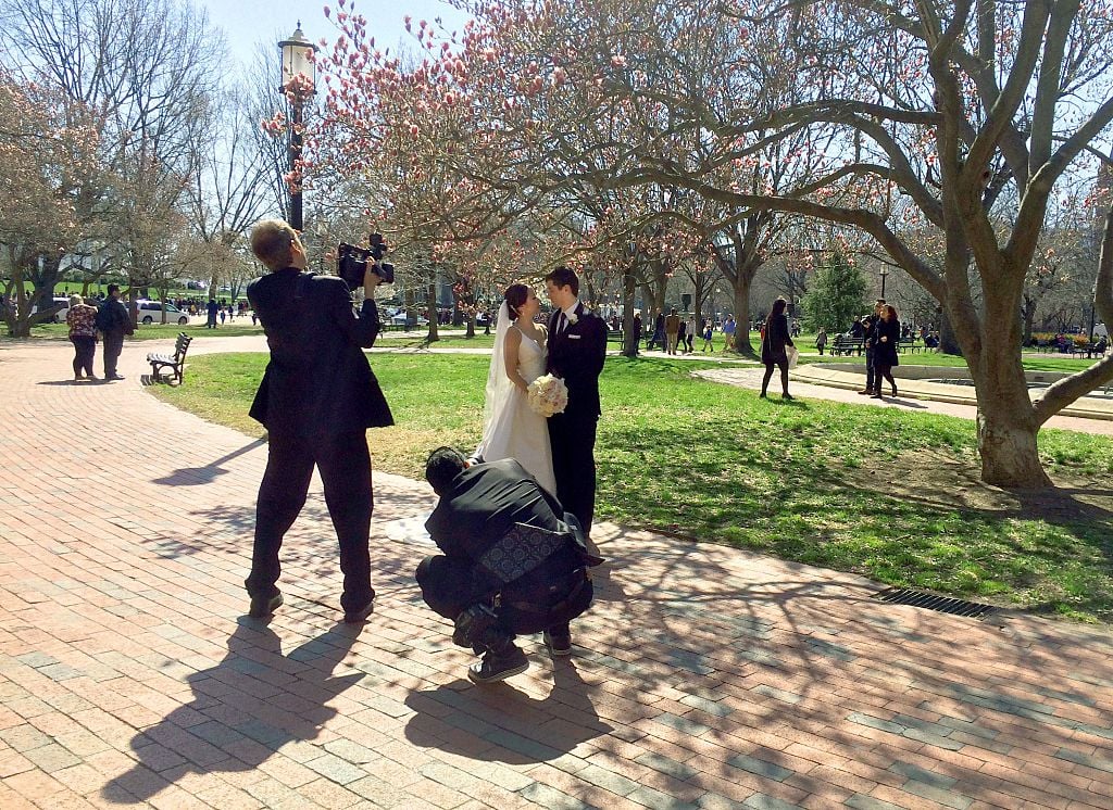 A couple has their wedding photos taken in Lafayette Park across from the White House i