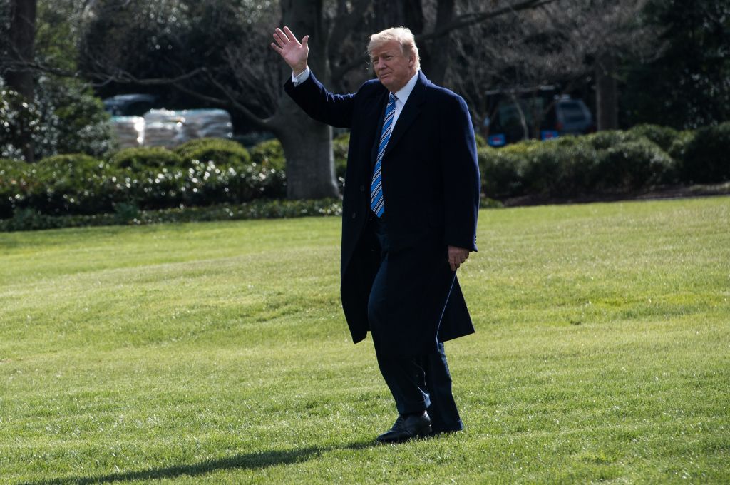 US President Donald Trump waves as he departs the White House