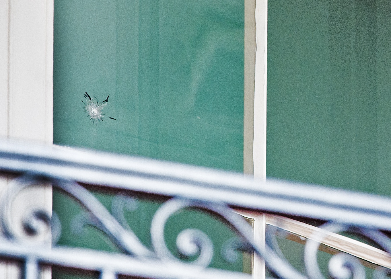 The bullet hole in the window at the White House