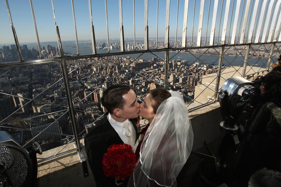 Whitney Edwards and Tim Randall kiss on the 86th Floor Observatory of the Empire State Building