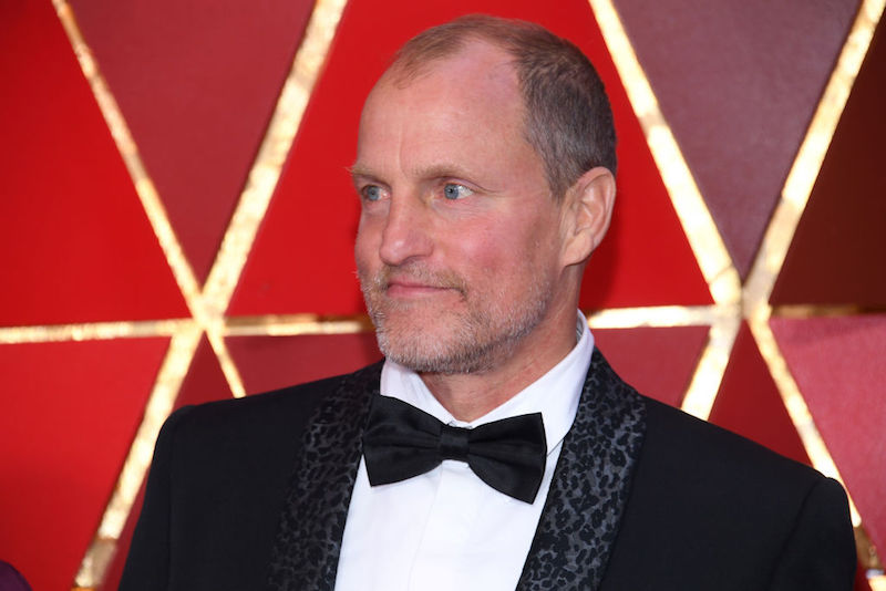 Woody Harrelson wearing a black tuxedo and bowtie while on a red carpet. Woody Harrelson wearing a black tuxedo and bowtie while on a red carpet.