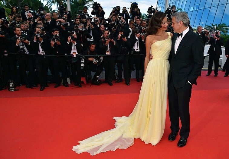 US actor George Clooney (R), and his wife British-Lebanese lawyer Amal Clooney pose on May 12, 2016 as they arrive for the screening of the film "Money Monster" at the 69th Cannes Film Festival in Cannes, southern France. US actor George Clooney (R), and his wife British-Lebanese lawyer Amal Clooney pose on May 12, 2016 as they arrive for the screening of the film "Money Monster" at the 69th Cannes Film Festival in Cannes, southern France.