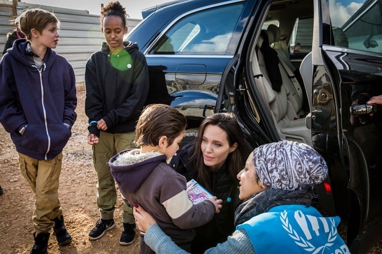 Angelina Jolie, accompanied on the trip by daughters Shiloh, 11, and Zahara, 13, speaks with a young Syrian refugee boy outside his home January 28, 2018 in Zaatari refugee camp, Jordan. Angelina Jolie, accompanied on the trip by daughters Shiloh, 11, and Zahara, 13, speaks with a young Syrian refugee boy outside his home January 28, 2018 in Zaatari refugee camp, Jordan.