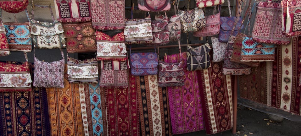 colorful fabrics and other folk products at a roadside stall