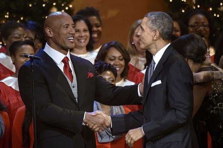 Dwayne "The Rock" Johnson and US President Barack Obama shake hands during a taping of the Christmas in Washington concert at the National Building Museum December 14, 2014 in Washington, DC. Obama and the first family attended the charity concert to benefit the Children's National Medical Center.