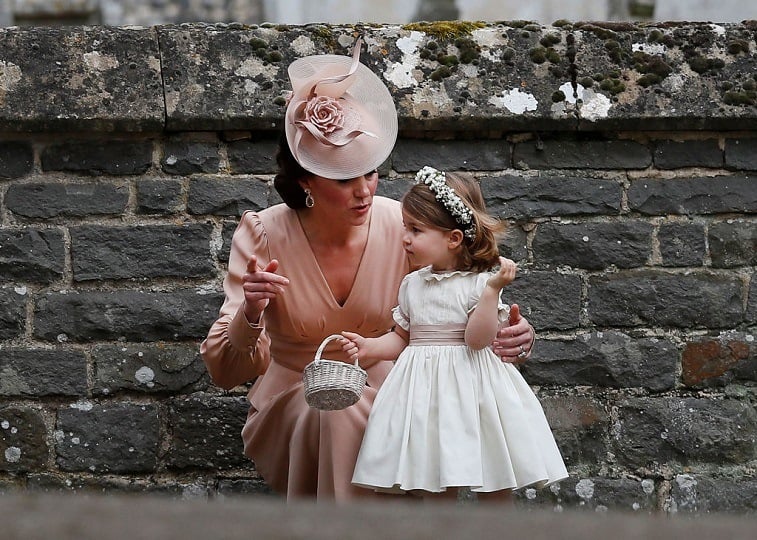 Catherine, Duchess of Cambridge speaks to Princess Charlotte after the wedding of Pippa Middleton and James Matthews at St Mark's Church on May 20, 2017 in in Englefield, England.