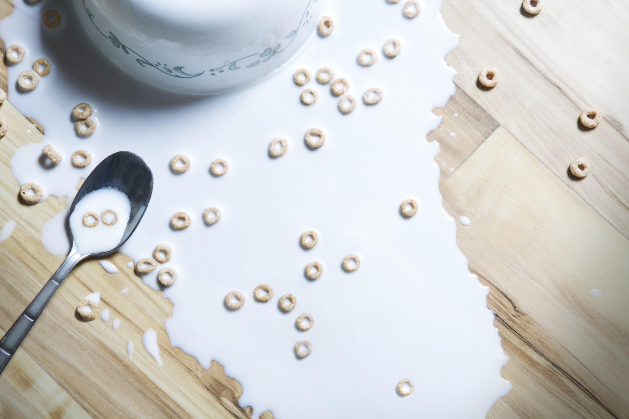 spilled cereal on a wood floor