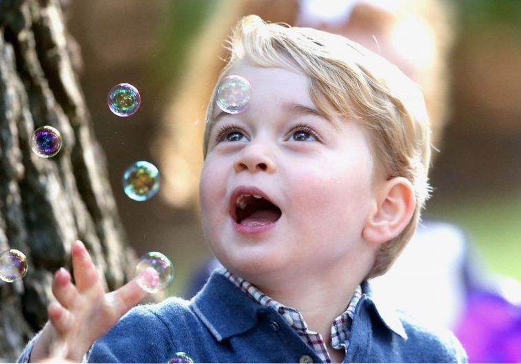 Prince George of Cambridge plays with bubbles at a children's party