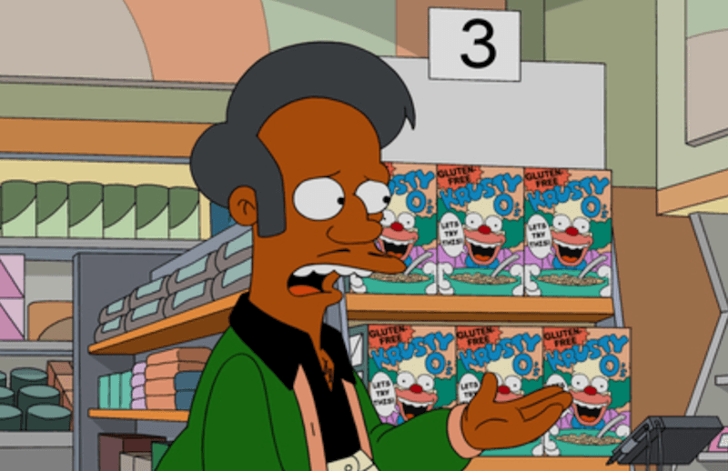 Apu talking to a customer inside his market.