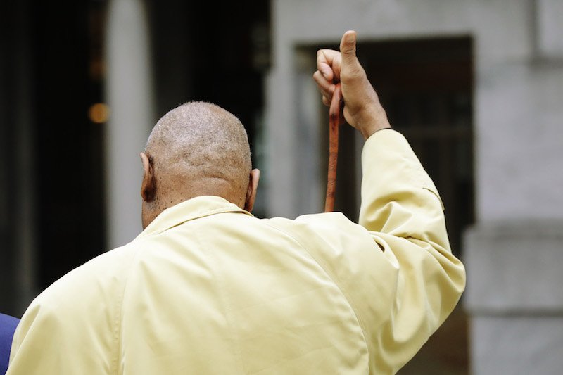 Bill Cosby gesturing while heading towards his car. Bill Cosby gesturing while heading towards his car.