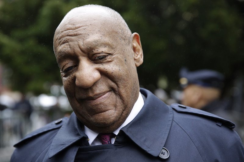 Bill Cosby standing outside a courthouse. Bill Cosby standing outside a courthouse.