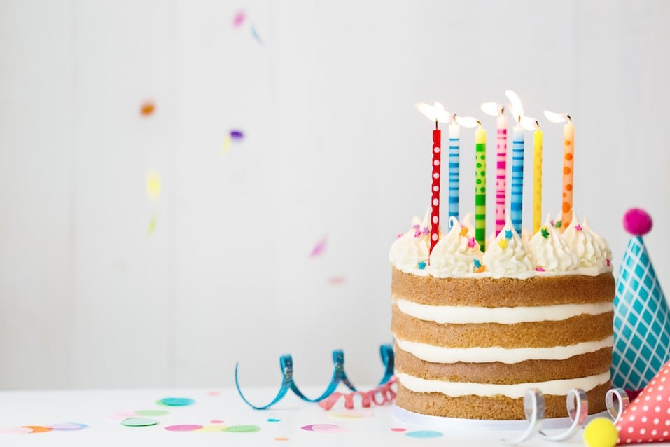 Birthday cake with colorful candles at a birthday party