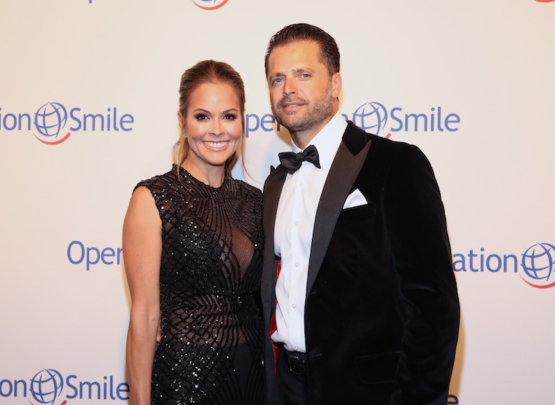Brooke Burke-Charvet and David Charvet posing on a red carpet together. Brooke Burke-Charvet and David Charvet posing on a red carpet together.