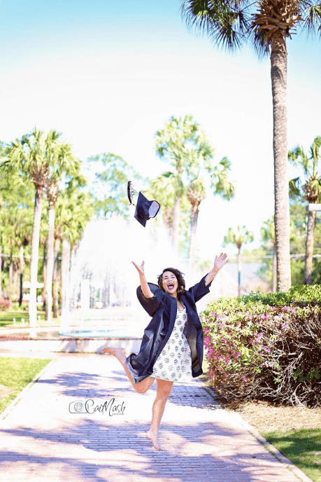 Girl jumping in her graduation photo