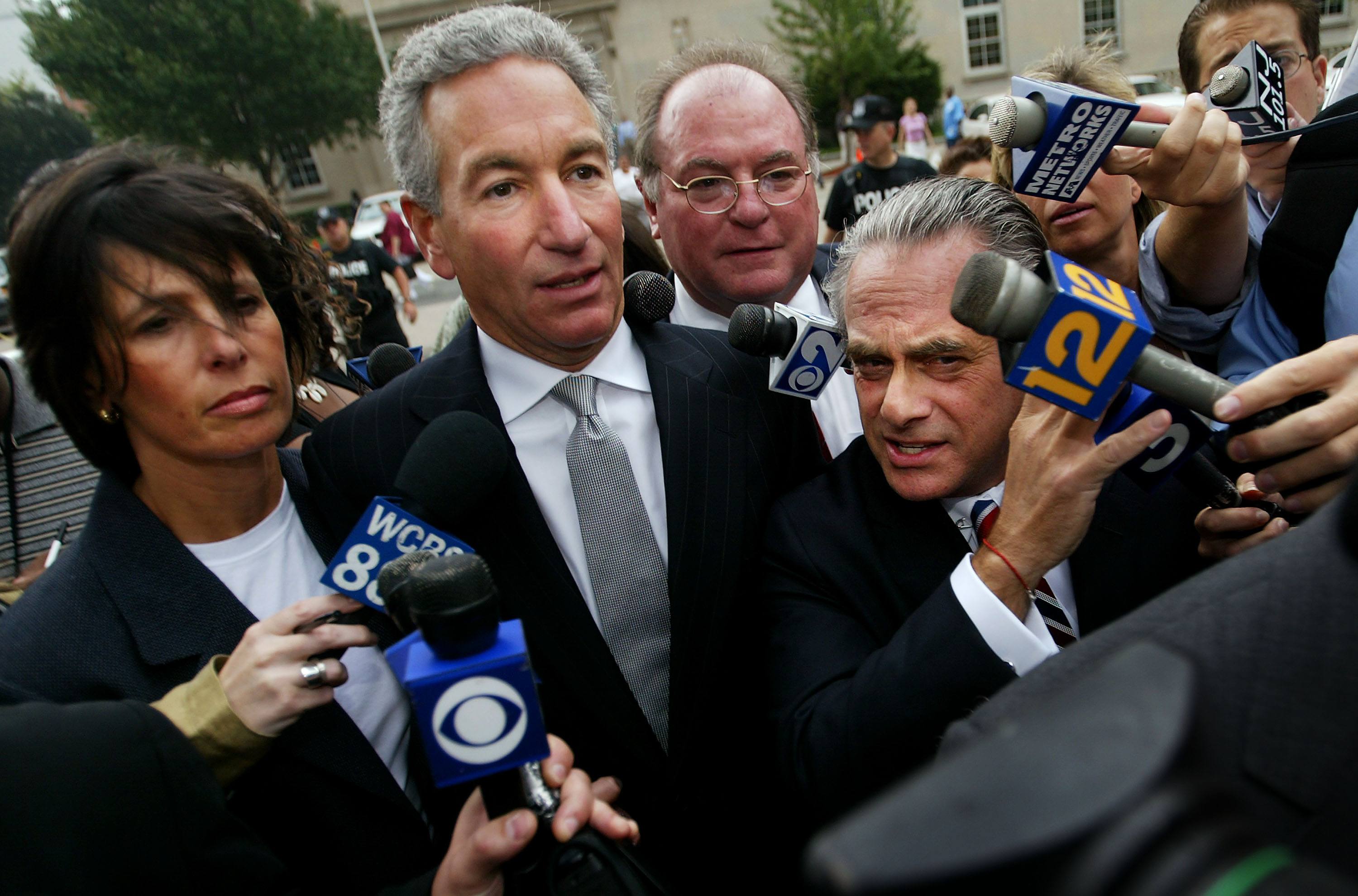 Charles Kushner (C) wades though the media with his legal team and wife 