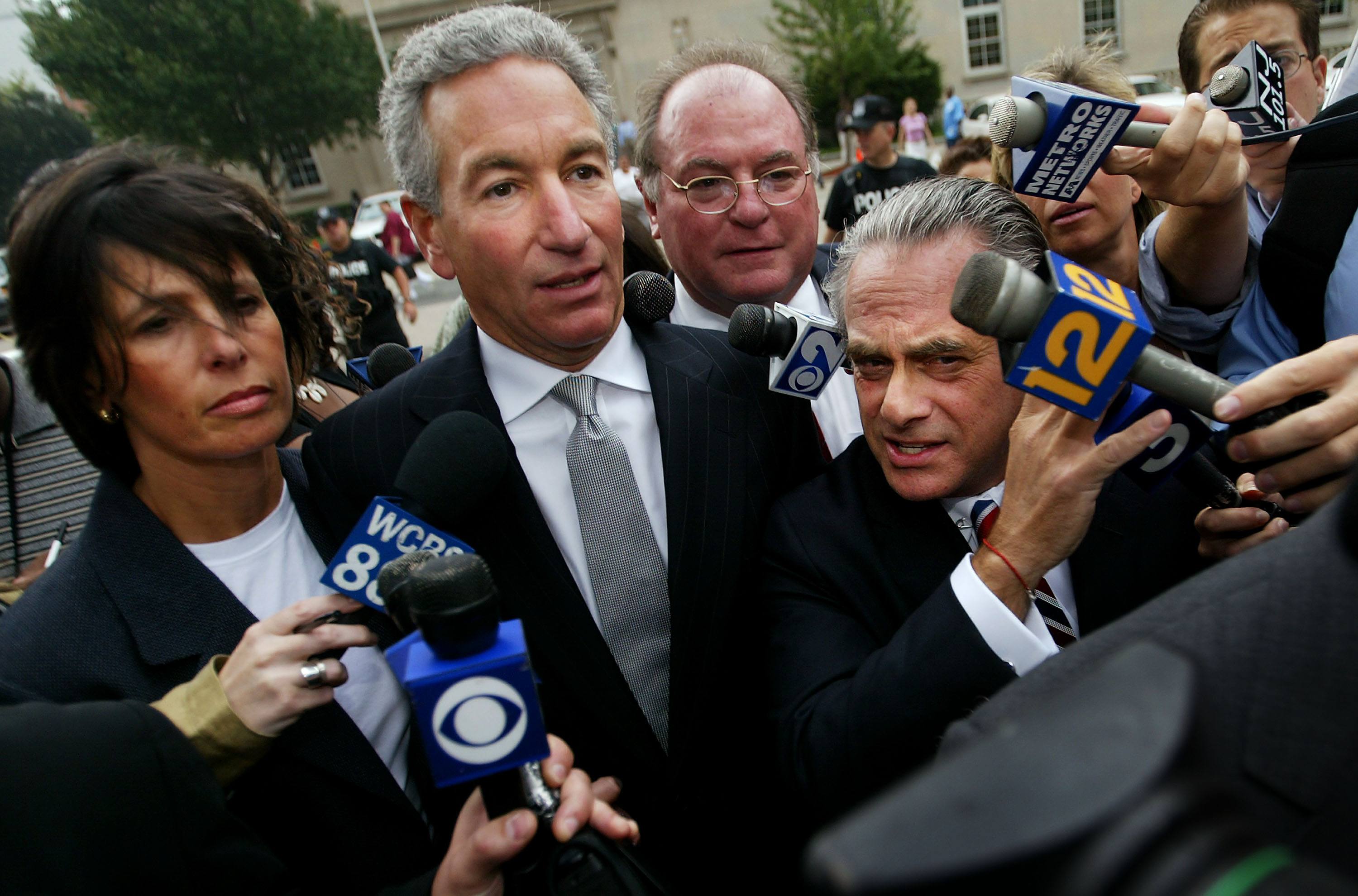 Charles Kushner (C) wades though the media with his legal team and wife