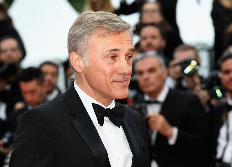 Christoph Waltz posing on a red carpet while in a tuxedo.