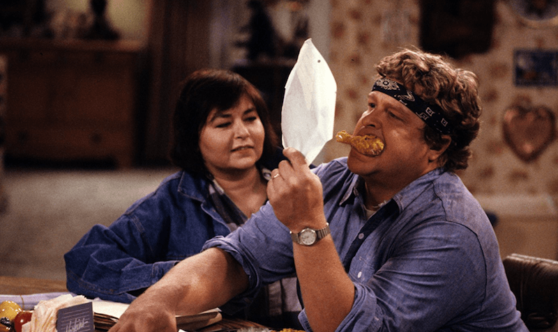 Roseanne and Dan sit in the kitchen. Roseanne and Dan sit in the kitchen.