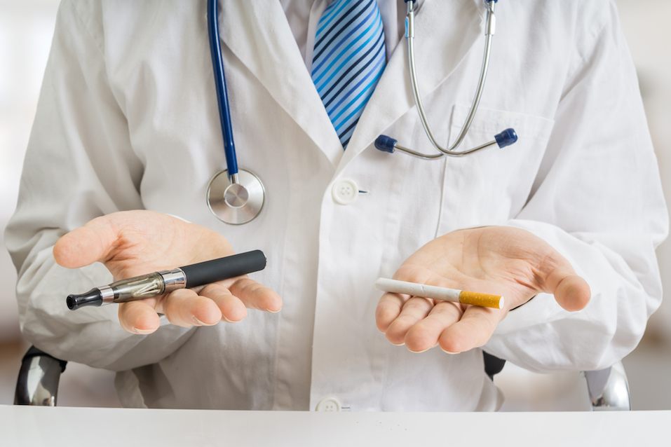 Doctor is comparing electronic vaporizer and conventional tobacco cigarette Doctor is comparing electronic vaporizer and conventional tobacco cigarette