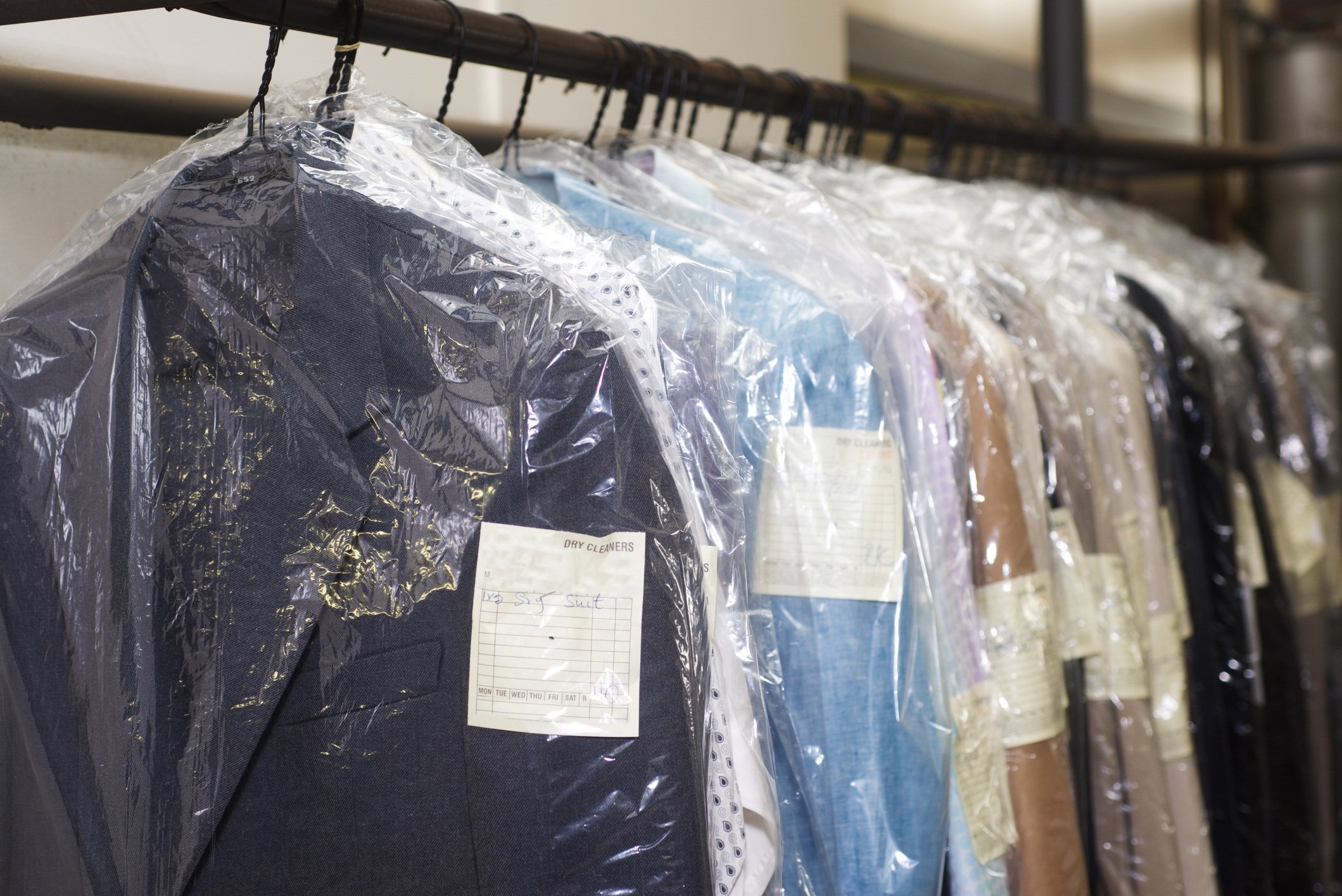 Dry cleaning things hanging in a row
