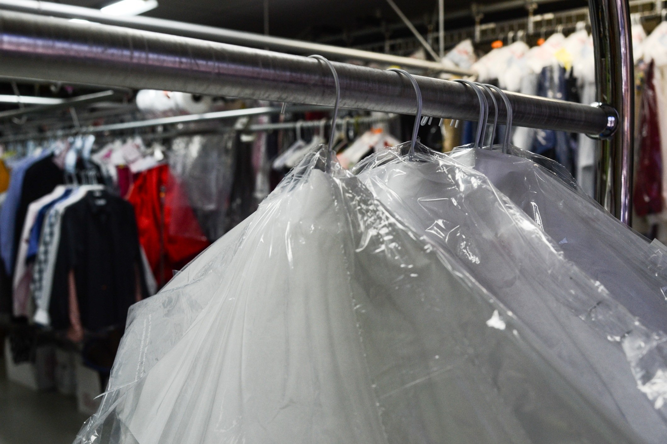 Dry cleaned clothes in plastic with business in back