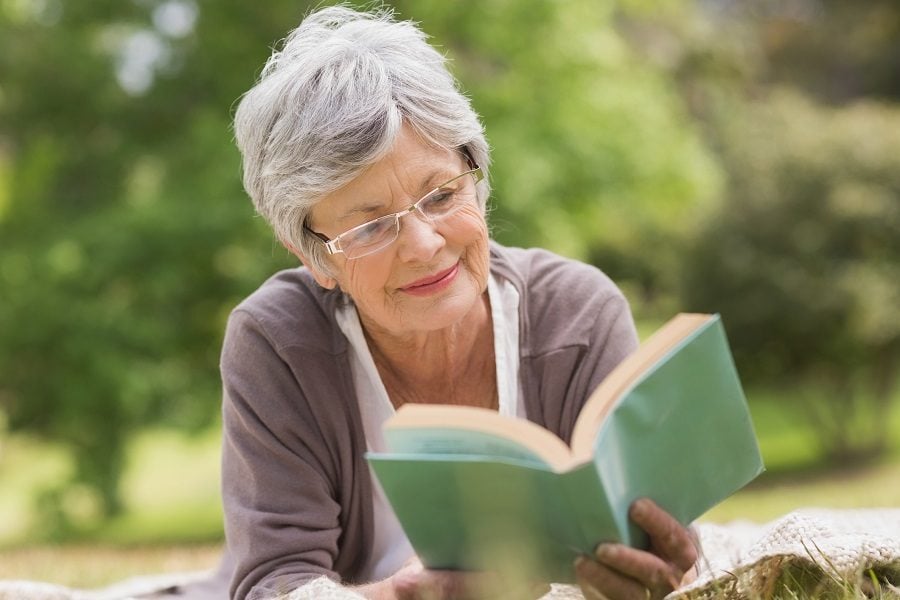 Elderly woman reading book