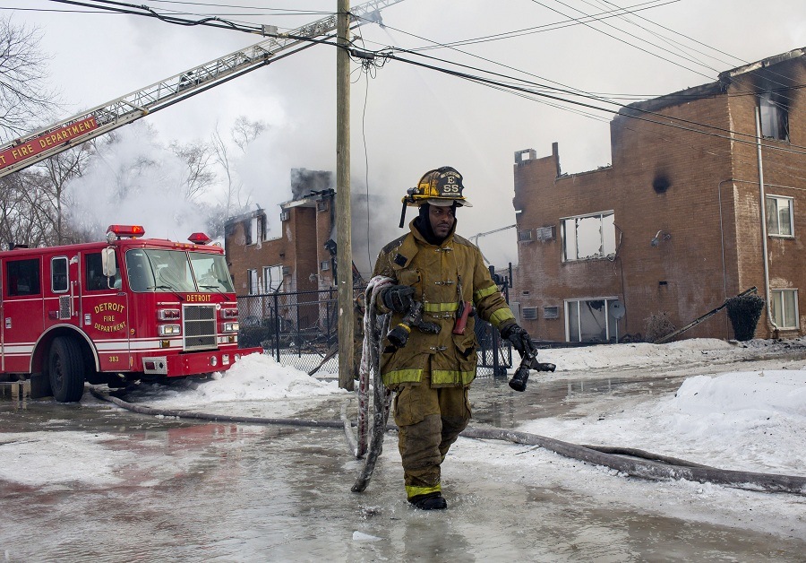 Firefighters battle an apartment fire