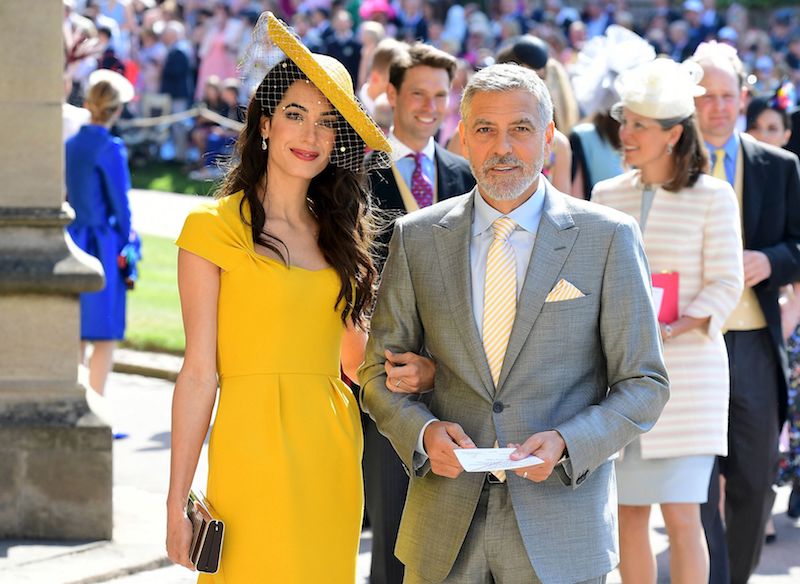 US actor George Clooney (R) and his wife British lawyer Amal Clooney (L) arrive for the wedding ceremony of Britain's Prince Harry, Duke of Sussex and US actress Meghan Markle at St George's Chapel, Windsor Castle, in Windsor, on May 19, 2018. (Photo by Ian West / POOL / AFP) (Photo credit should read IAN WEST/AFP/Getty Images)