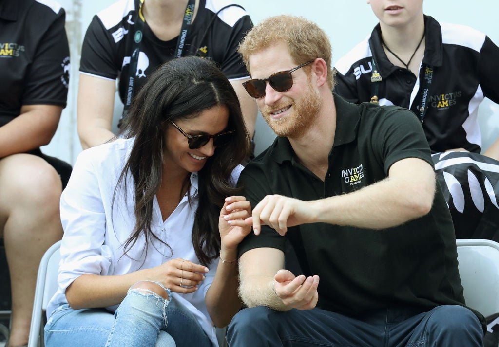 Prince Harry and Meghan Markle (L) attend a Wheelchair Tennis match during the Invictus Games