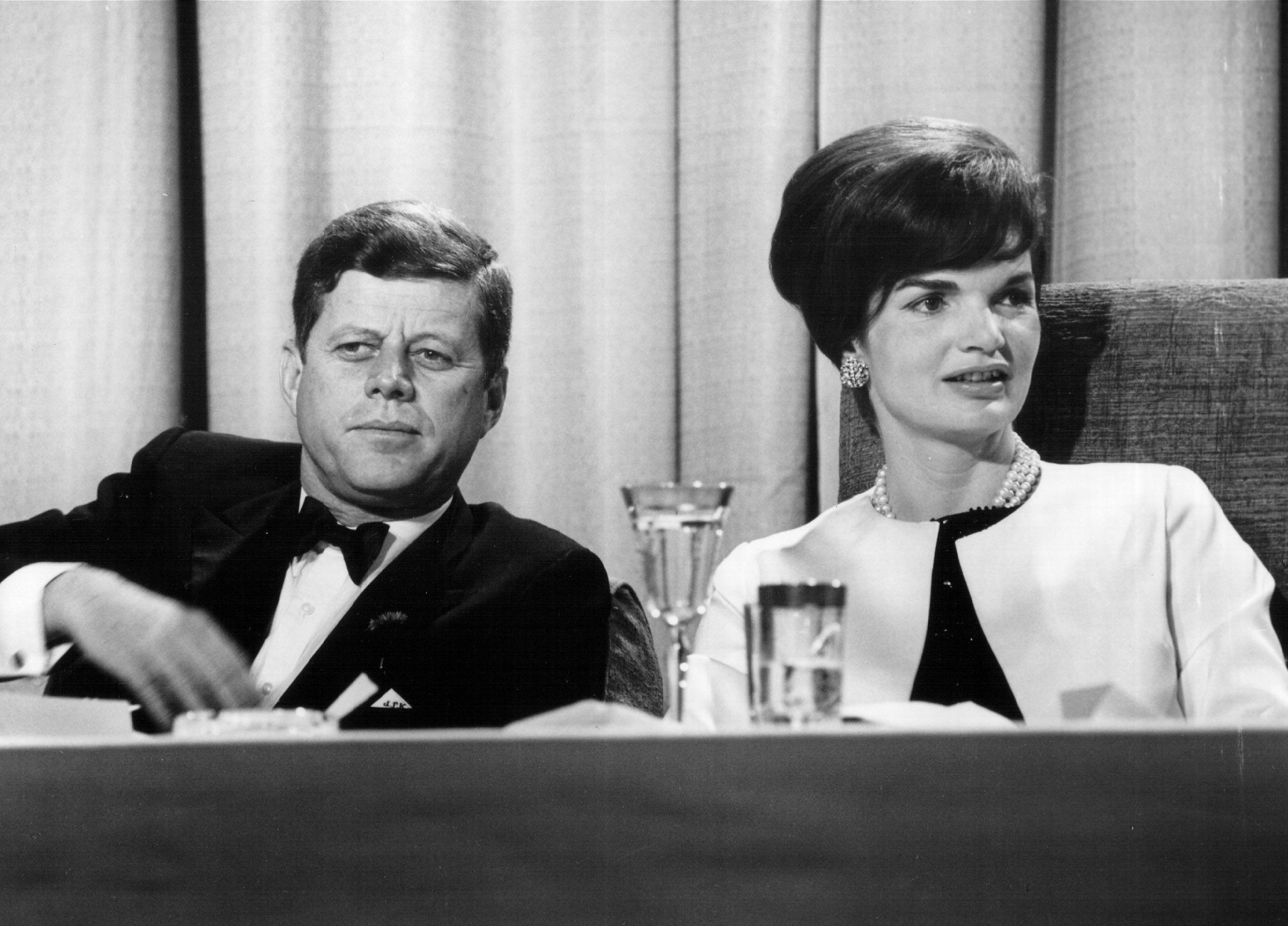 President John F. Kennedy and First Lady Jackie Kennedy seated at a table