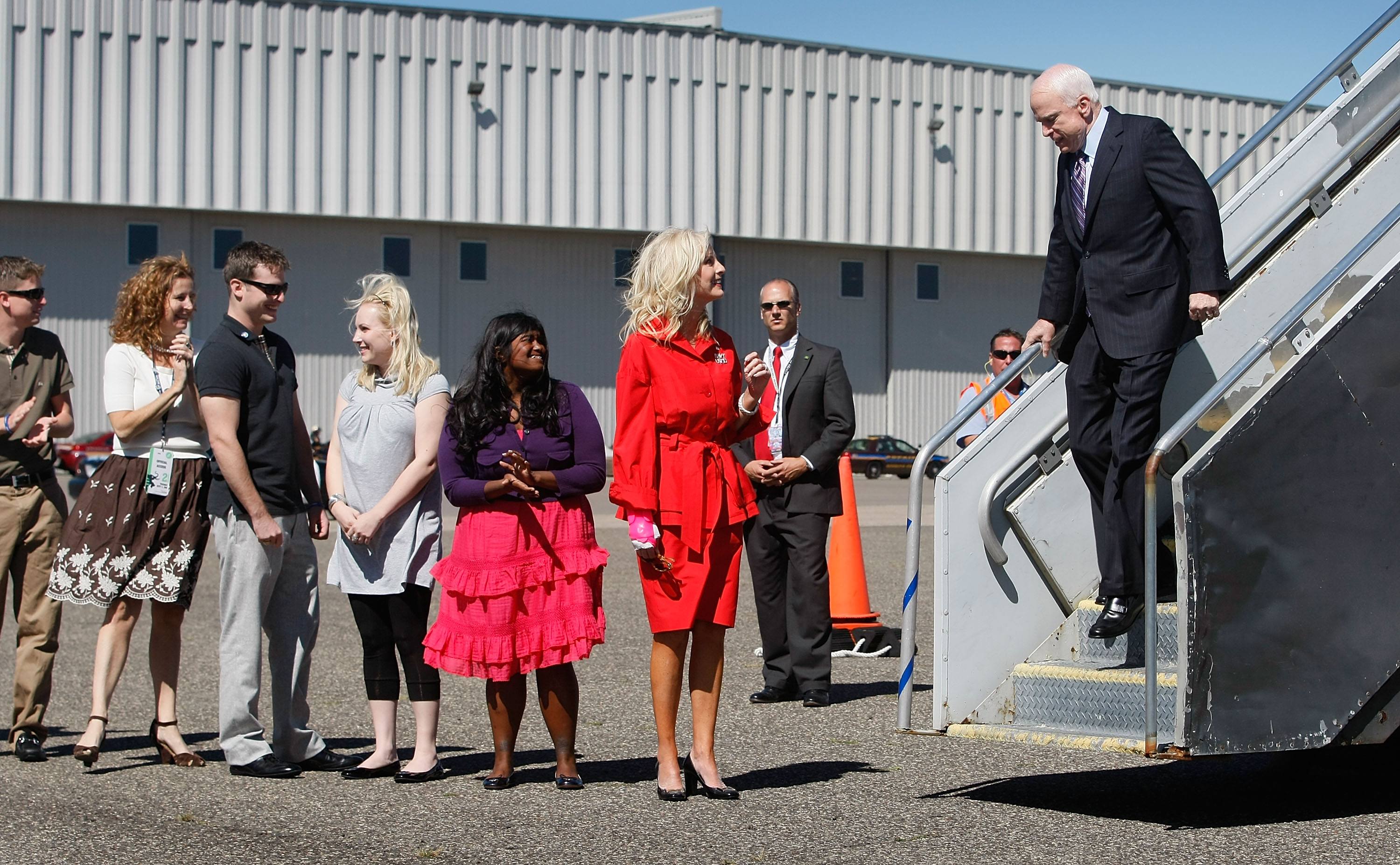 John McCain walking off plane with his family