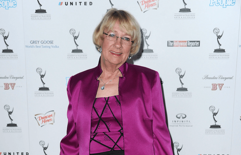 Kathryn Joosten wearing a pink outfit on a red carpet. Kathryn Joosten wearing a pink outfit on a red carpet.