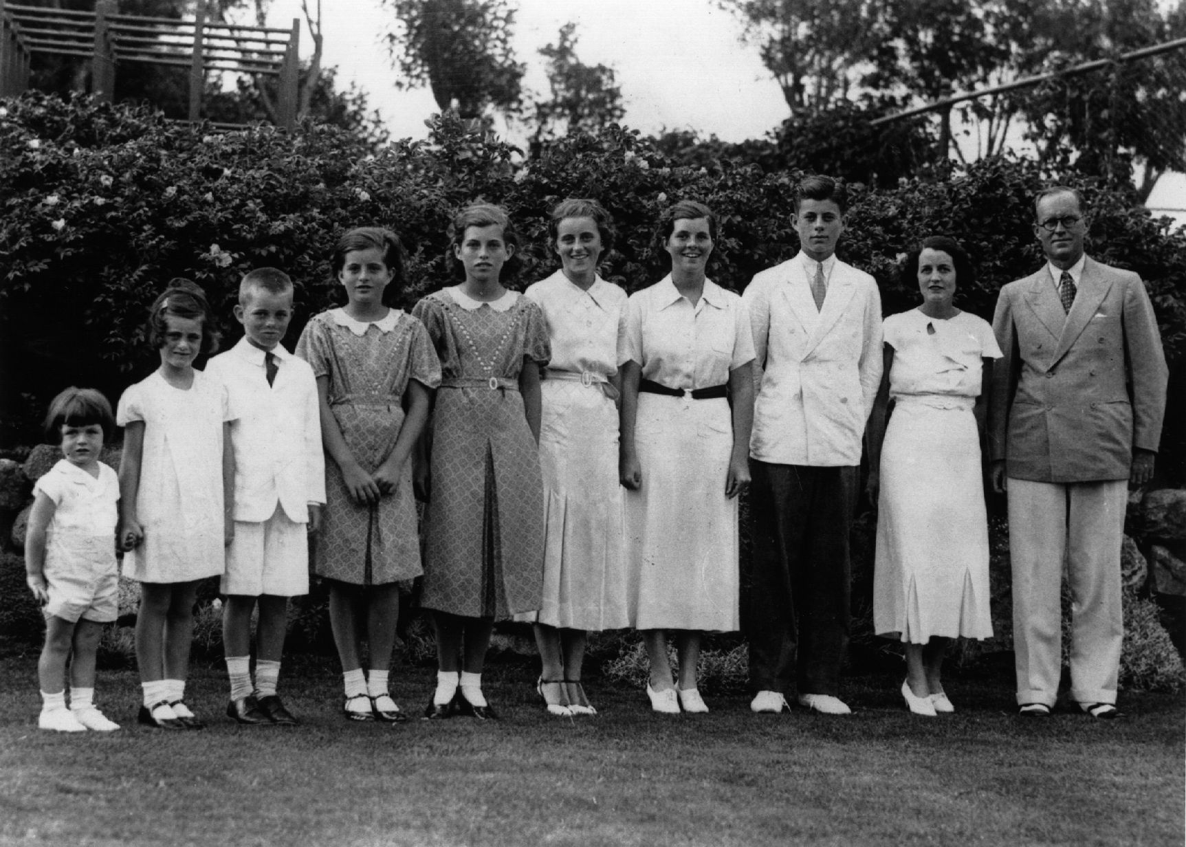 American multi-millionaire Joseph Patrick Kennedy (right), the newly-appointed ambassador to London, with his wife Rose Kennedy (second from right) and eight of their nine children, in London. From left: Edward, Jeanne, Robert, Patricia (1924 - 2006), Eunice, Kathleen, Rosemary and John F Kennedy