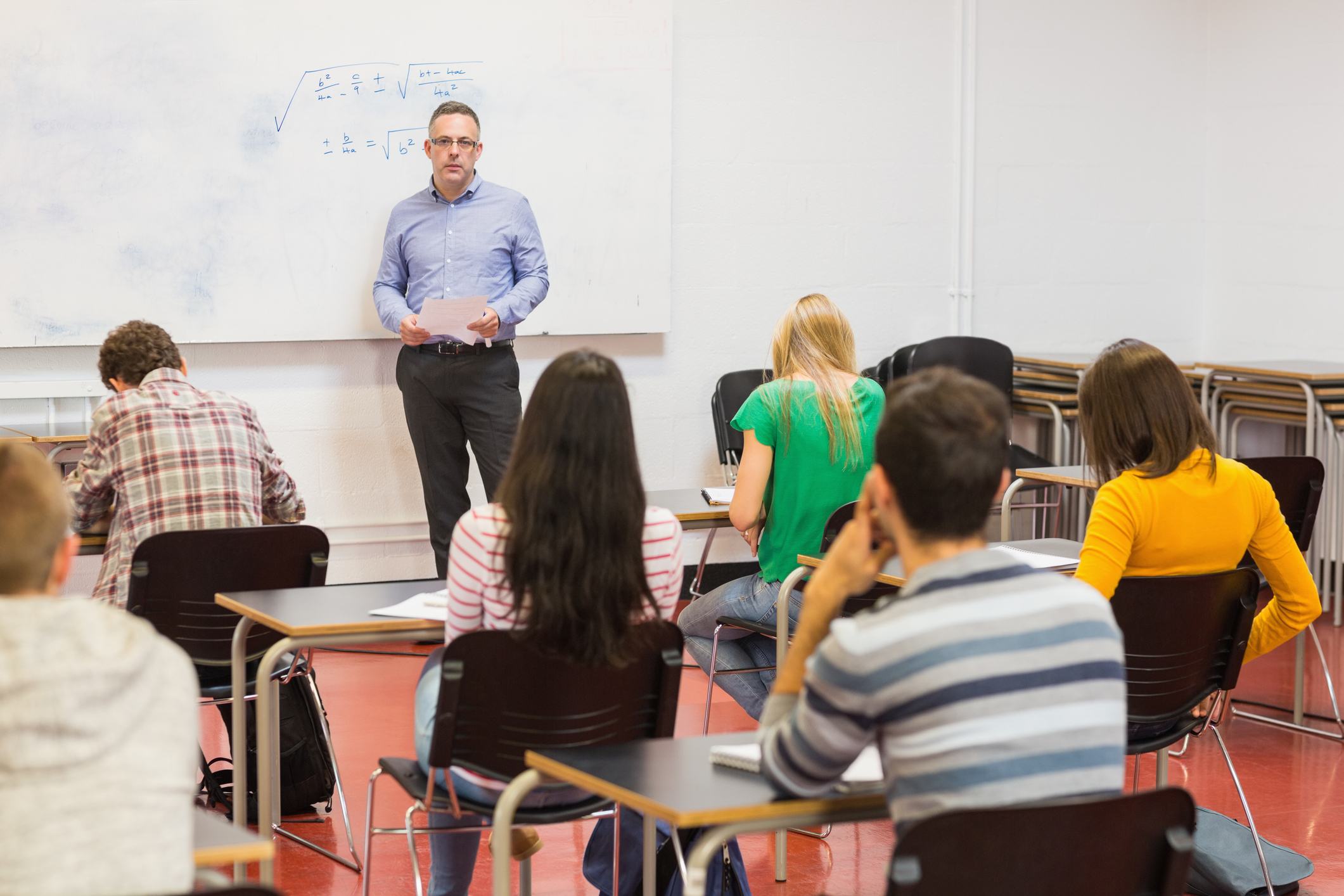 Attentive students with teacher in the classroom