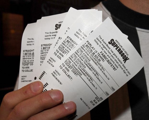 Jake Sindberg of Wisconsin displays his betting tickets