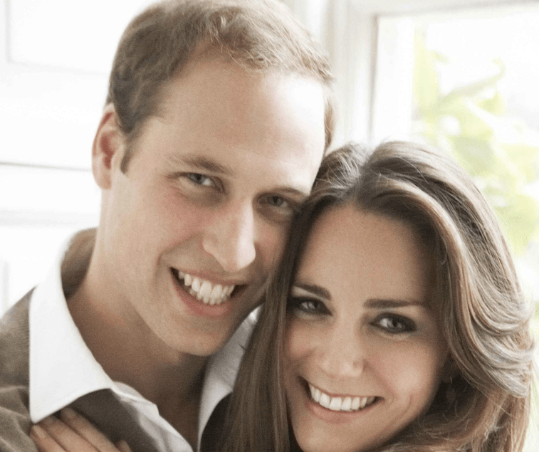Prince William smiling with Kate Middleton. 